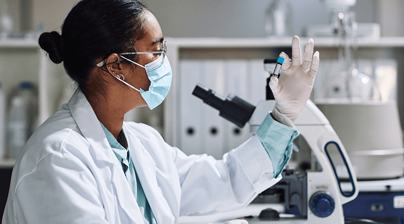 Pathologist in a laboratory examining a sample