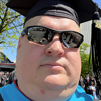 Brad in a graduation cap
